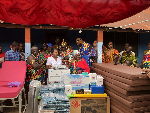 Edith Arthur receiving the items while flanked by other dignitaries