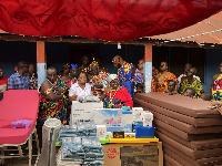 Edith Arthur receiving the items while flanked by other dignitaries