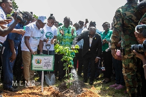 President Akufo-Addo planting a tree together with some officials