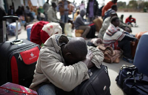 A photo of a group of people stranded and carrying their luggages | File Photo