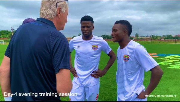 Rene Hiddink interacting with some players of Hearts of Oak at Pobiman