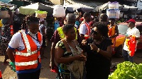 Sanitation Minister Cecilia Abena Dapaah speaking to a market woman at Agbogloshie market