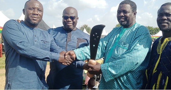 Ali Lukeman (second right) receiving the sword of honour from his predecessor