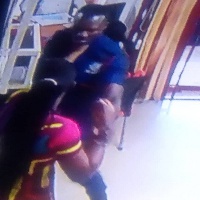 The angry female customer of GN Bank assaulted the police officer on guard duty