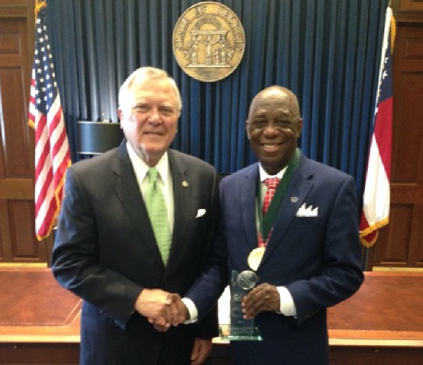 Dr. Mensah (right) with the NAI Plaque congratulated by Governor Deal of Georgia