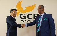 Managing Director of GCB Bank Limited, Anselm Ray Sowah (R) in a handshake with Liu Jianshe