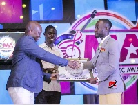 Okyeame Kwame (R) recieves award