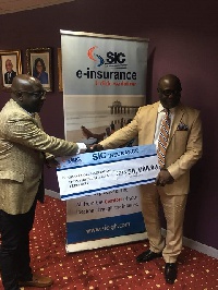 Mr Andoh(L) receiving the dummy cheque from CFA, Mr Adu-Poku