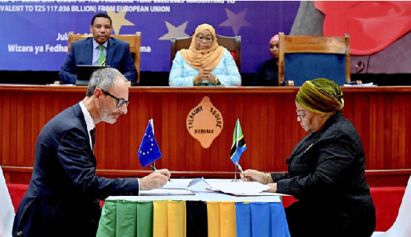 Tanzania President Samia Suluhu Hassan (centre) with Finance Minister Mwigulu L. Nchemba witness the