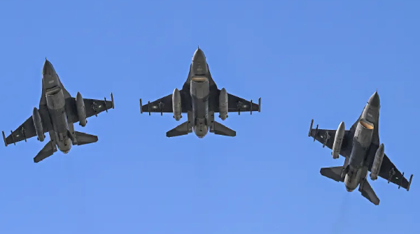 Pakistan's F-16 jets fly past over the president's house during the national day parade in Islamabad