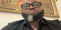 A picture  of Emmanuel Kotin speaking in an interview on Tv3