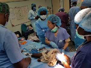 A child with cleft lip palate being operated by doctors