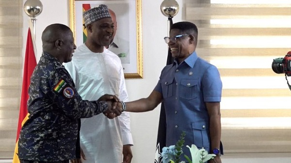 ACP Dr Benjamin Agordzo (Right in Blue) in a handshake with the IGP Yohuno and the Interior Minister