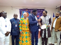UNIPGC Global Vice President presenting induction certificate to Prof. Hugh K. Aryee