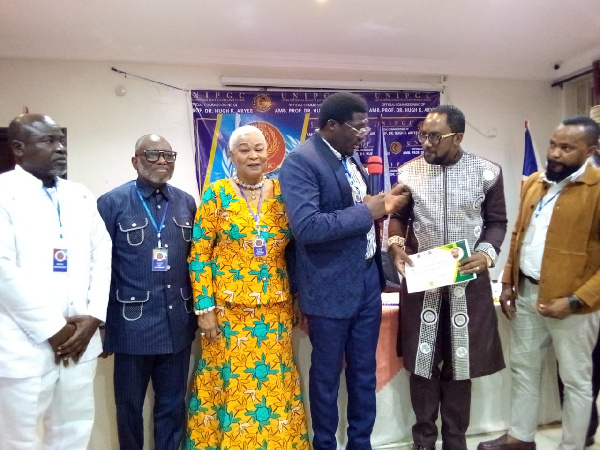 UNIPGC Global Vice President presenting induction certificate to Prof. Hugh K. Aryee
