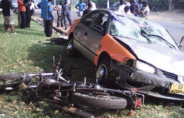 The damaged taxi and motorbike at the robbery scene
