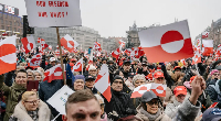 Protesters in Copenhagen waved Greenland's white and red flag in support of self-determination