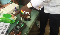 Electoral officers in some polling stations manually verify voters after the machine failed