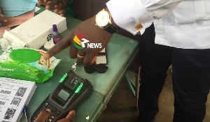 Electoral officers in some polling stations manually verify voters after the machine failed