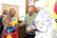 Togbui Amenya Fiti V, Paramount Chief of the Aflao Traditional Area, presenting a gift to President