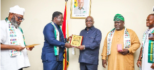 The AU special envoy confering the award on Eric Opoku