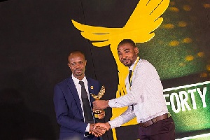Roger Agambire Agana receiving his award