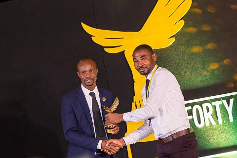 Roger Agambire Agana receiving his award