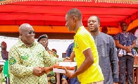 President Akufo-Addo shaking hands with a student
