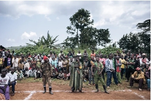 CODECO militiamen and members of the Lendu community attend a meeting with former strongmen in Wadda