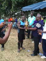GRA lone goal hero Kwasi Anim (left) receives the 2018 Males Fetu Afahye trophy