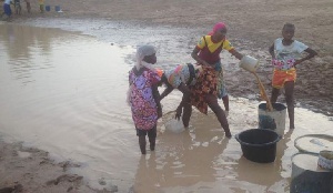 Residents of Sagnarigu fetch water from a muddy pond during water crisis