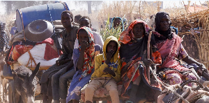 Displaced people ride an animal-drawn cart, following RSF attacks on Zamzam displacement camp