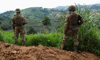 Members of the Armed Forces of the DRC  stand guard against the M23 rebel group