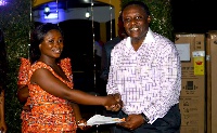 Mr Baiden handing over a prize to Eunice Boatemaa