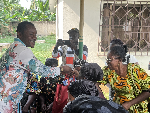 Picture of Dr Parker giving his donation to widows