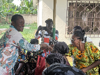 Picture of Dr Parker giving his donation to widows
