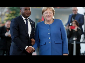 German Chancellor Angela Merkel, right, and Benin's Economy and Finance Minister Romuald Wadagni