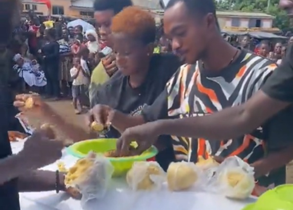 Friends of deceased captured eating banku on his coffin