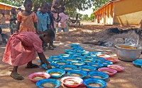 Some children being served food at a school