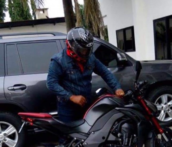 President Mahama gets ready to ride on his motorbike.