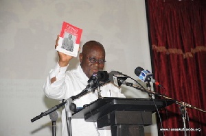 Nana Addo holding a copy of the book