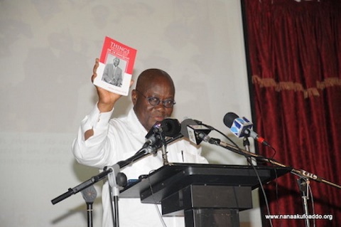 Nana Addo holding a copy of the book