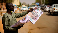 A man in Niger's capital Niamey sells newspapers featuring a report on a recent attack