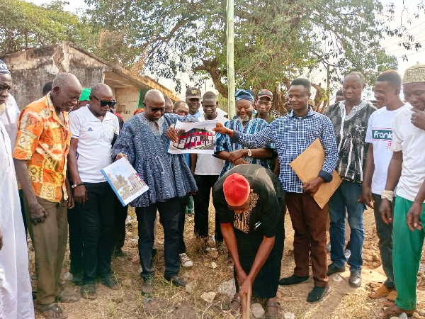 Abu Kansangbata is joined by some leaders to cut the sod