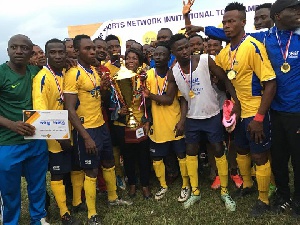 Players of Score Soccer Academy displaying their trophy