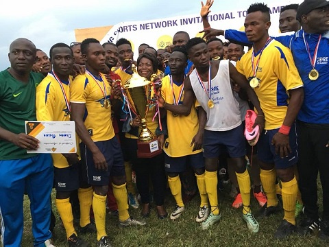 Players of Score Soccer Academy displaying their trophy