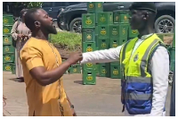 A police officer and a pedestrian exchanging words at the accident scene