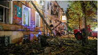 A firefighter works at a site of a building damaged during Russian missile and drone strike