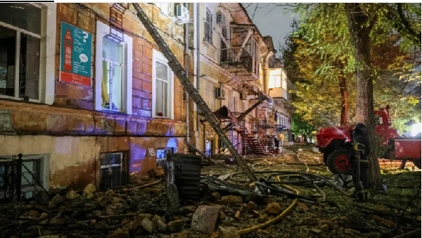 A firefighter works at a site of a building damaged during Russian missile and drone strike