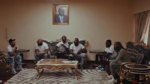 Screenshot of Meek Mill (third left) surrounded by his team in the music video